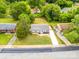 Aerial view of gray home with a large front yard and long driveway nestled between two other homes at 2511 Linwood Rd, Gastonia, NC 28052