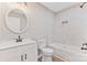 Modern bathroom featuring a vanity, round mirror, tub, and tiled wall and floor at 2511 Linwood Rd, Gastonia, NC 28052