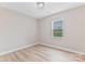 Minimalist bedroom with a neutral palette and wood-look floors receiving great natural light at 2511 Linwood Rd, Gastonia, NC 28052