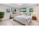 Bright bedroom featuring neutral walls, wood-look floors, two windows, and elegant coastal decor at 2511 Linwood Rd, Gastonia, NC 28052