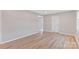 Cozy living room features hardwood flooring, neutral paint, and a spacious open floor plan at 2511 Linwood Rd, Gastonia, NC 28052