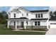 Charming two-story home with stone accents, covered front porch, and manicured lawn at 2517 Mabel Ln, Monroe, NC 28110
