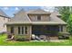 Brick home with a screened in porch overlooks the backyard and patio area, perfect for outdoor entertaining at 309 Palm Cove Way, York, SC 29745