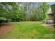 Expansive backyard features lush green grass, mature trees, and a stone patio perfect for entertaining or relaxing at 309 Palm Cove Way, York, SC 29745