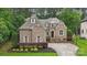 Elegant brick home boasts mature trees, beautiful landscaping, gabled roof, and a private driveway with meticulous curb appeal at 309 Palm Cove Way, York, SC 29745