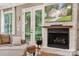 Cozy fireplace with stone surround, rustic mantle and French doors to outdoor space at 309 Palm Cove Way, York, SC 29745