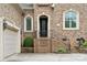 Charming brick home featuring a side-entry garage, front door with a covered porch and manicured landscaping at 309 Palm Cove Way, York, SC 29745