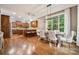 Open kitchen and dining area with hardwood floors, a breakfast bar, and stainless steel appliances at 309 Palm Cove Way, York, SC 29745