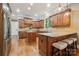 Gourmet kitchen with granite countertops, custom cabinetry, and a central island with bar stool seating at 309 Palm Cove Way, York, SC 29745