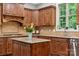 Close-up of a kitchen island featuring granite countertops, custom cabinetry, and stainless steel appliances at 309 Palm Cove Way, York, SC 29745