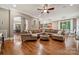 Spacious living room featuring a large sectional sofa, hardwood floors, and an open floor plan at 309 Palm Cove Way, York, SC 29745
