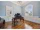 A home office featuring an arched window, hardwood floors, and classic trimwork at 309 Palm Cove Way, York, SC 29745