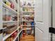 Organized walk-in pantry with custom shelving, providing ample storage space for all of your food items at 309 Palm Cove Way, York, SC 29745