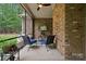 Cozy screened in porch with fan, brick wall, outdoor grill, and a small television for year-round enjoyment at 309 Palm Cove Way, York, SC 29745