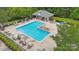A community swimming pool with lounge chairs and tables for relaxation and socializing at 309 Palm Cove Way, York, SC 29745