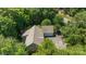Aerial view showcasing a home with mature trees, a two car garage, and a large driveway at 327 Wilby Dr, Charlotte, NC 28270