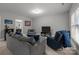 Cozy basement living area with comfortable seating and a large television at 327 Wilby Dr, Charlotte, NC 28270