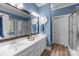 Stylish primary bathroom with double sinks, a large mirror, and a walk-in shower at 327 Wilby Dr, Charlotte, NC 28270