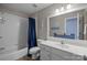 Charming bathroom with baseball themed decor, white vanity, and shower with blue curtain at 327 Wilby Dr, Charlotte, NC 28270