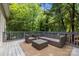 Inviting outdoor deck with wicker furniture, perfect for relaxing in a serene wooded setting at 327 Wilby Dr, Charlotte, NC 28270