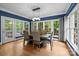Bright and airy dining room with large windows, hardwood floors, and modern lighting at 327 Wilby Dr, Charlotte, NC 28270