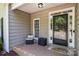 Cozy front porch with brick flooring, seating, and charming exterior details at 327 Wilby Dr, Charlotte, NC 28270