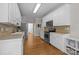 Traditional kitchen with white cabinets, stainless steel appliances, and hardwood floors at 327 Wilby Dr, Charlotte, NC 28270