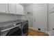 Functional laundry room with modern washer and dryer units and convenient storage at 327 Wilby Dr, Charlotte, NC 28270