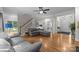 Open-concept living room with hardwood floors, a fireplace, and plenty of natural light at 327 Wilby Dr, Charlotte, NC 28270