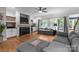 Bright living room featuring a fireplace, large windows, and hardwood flooring at 327 Wilby Dr, Charlotte, NC 28270