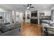 Elegant living room with a fireplace, hardwood floors, and open access to other living areas at 327 Wilby Dr, Charlotte, NC 28270
