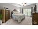 Serene bedroom with neutral tones, a plush bed, and a large window for natural light at 327 Wilby Dr, Charlotte, NC 28270