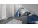 Finished attic bonus room with play slide, toy storage, and a cozy reading nook with blue couch at 327 Wilby Dr, Charlotte, NC 28270