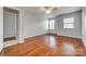 Spacious primary bedroom features hardwood floors, a ceiling fan, and large windows at 328 Rose Garden Ct, Rock Hill, SC 29732