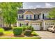 Inviting townhouse featuring well-maintained landscaping, a garage, and neutral siding at 328 Rose Garden Ct, Rock Hill, SC 29732