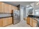 Modern kitchen with stainless steel refrigerator, granite countertops, and tile backsplash at 328 Rose Garden Ct, Rock Hill, SC 29732