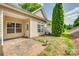 Cozy back patio with brick pavers, lush greenery, and a well-maintained yard at 328 Rose Garden Ct, Rock Hill, SC 29732