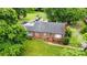 An aerial view of a well-maintained brick home and a lush, green landscape at 3700 Nevin Rd, Charlotte, NC 28269
