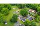 This aerial view shows the wooded area of a lot for sale, with several structures nearby at 3700 Nevin Rd, Charlotte, NC 28269