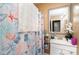 Bright bathroom featuring a framed mirror, vanity with sink, and shower with decorative curtain at 3700 Nevin Rd, Charlotte, NC 28269