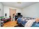 Comfortable bedroom featuring hardwood floors, dresser, TV, and inviting floral-patterned bedding at 3700 Nevin Rd, Charlotte, NC 28269