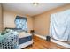 Cozy bedroom with wood floors, natural light and minimalist decor, great potential at 3700 Nevin Rd, Charlotte, NC 28269