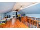 An upstairs bonus room offers hardwood floors and a small view into an adjoining bathroom at 3700 Nevin Rd, Charlotte, NC 28269