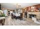 Inviting dining room with fireplace, brick accent wall, and table with seating for six at 3700 Nevin Rd, Charlotte, NC 28269