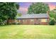 Charming brick home featuring a well-manicured front lawn and classic architectural details, great curb appeal at 3700 Nevin Rd, Charlotte, NC 28269