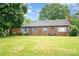 Charming brick home featuring a well-manicured front lawn and classic architectural details, great curb appeal at 3700 Nevin Rd, Charlotte, NC 28269