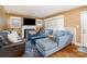 Cozy living room boasting a comfortable seating arrangement, fireplace, large TV, and plenty of natural light at 3700 Nevin Rd, Charlotte, NC 28269