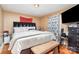 Spacious bedroom with large bed, upholstered headboard, bench and view to large TV at 3700 Nevin Rd, Charlotte, NC 28269