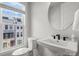 Half bath with white fixtures, sink and view of neighboring building at 4011 Tundra Rd, Charlotte, NC 28203