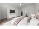 Well-lit bedroom with sleek TV console, neutral palette, and doorway to a Primary bath at 4011 Tundra Rd, Charlotte, NC 28203